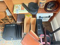 Group view showing book, cap, salt crock, frame, folios, letter tray, file box, file holders, desk stand