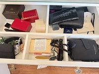Drawer with wallets, pouches, watch boxes, jewellery, shoe stretchers visible