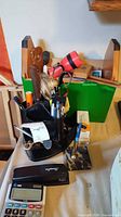 Desk organizer, flashlight, pen stand, file holder visible