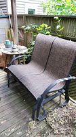 Glider bench and mosaic side table on deck