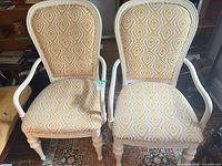 Pair of cream-painted wood armchairs with yellow geometric upholstery