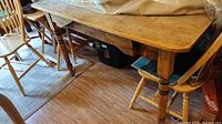 Full view of pine dining table with turned legs and distressed top