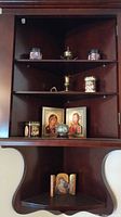Full shelf view showing icons, tins, cloisonné jar and brass items