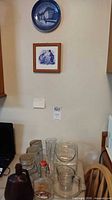 Overall lot showing Royal Copenhagen plate on wall and assorted glassware on table