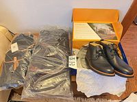All three items: boots in open box, duffel and backpack in plastic