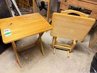 Two folding TV trays unfolded and folded, showing design and wear