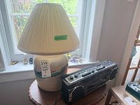 Boombox and ceramic lamp on small table