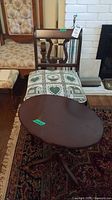 Chair with loose patterned cushion and oval table
