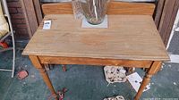 Top view of solid pine side table showing flat surface, backsplash, finish wear