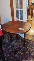 Table with leaves raised showing oval top and leg structure