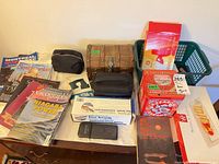 Overview of magazines, books, tins, neckrest box, wooden chest, pouches and translator