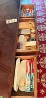 Open drawers showing all assorted toiletries and toothbrushes