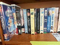 Shelf showing VHS titles Cinderella through Road Trip