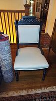 Full view of chair front showing upholstery and wood frame
