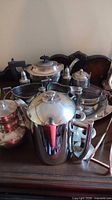 Group view showing coffee pot, sugar bowl, shakers, candlestick, additional serving pieces on tray