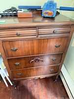 Front view of dresser showing all five drawers and hardware