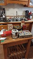 Decorative tins displayed on kitchen cart