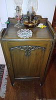 Front and top of cabinet showing carved door detail and finish