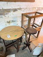 Group shot of round table, pedestal stand, and wood frames