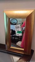 Full view of antique gold wall mirror on wall