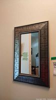 Front view of the rectangular mirror on wall showing entire frame and glass