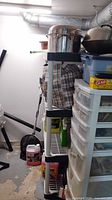 Full view of shelving unit with contents (not included) shows plastic construction and black joints