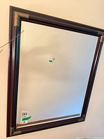 Front view of rectangular wood-framed mirror