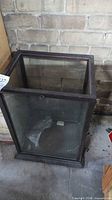 Full view of rectangular glass display case with wood frame