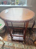 Top view of oval solid wood table showing scalloped edge and surface