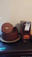 Stacked wooden bowls with box visible
