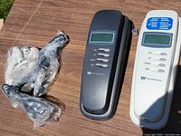 Two White-Westinghouse caller ID corded phones with bundled telephone cords