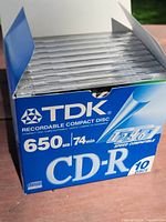 Open retail box showing stacked sealed CD-R jewel cases