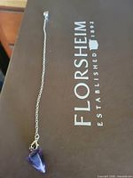 Full view of amethyst pendulum on chain
