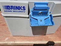 Front view showing Brinks logo and blue latch