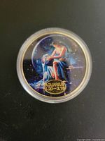 Obverse showing enameled Aquarius image and text