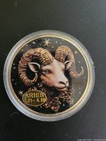 Obverse of Aries enamel token in capsule