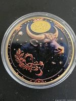Front of enameled Taurus token in capsule