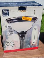 Front of factory box showing Home Styles floor lamp image and branding