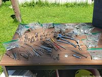 Full tabletop view showing assorted sockets, ratchets, extensions, lug wrench and drill bits