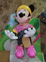 Front view of Minnie Mouse skating doll attached to inner tray