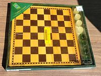 Front view of sealed Premier Collection checkers set showing board and pieces