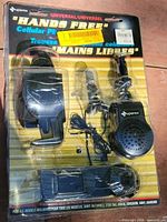 Front of sealed Superex hands-free cellular phone kit showing contents