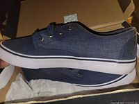 Left side view of navy blue Be You sneaker in box