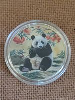 obverse showing enamel panda design in capsule