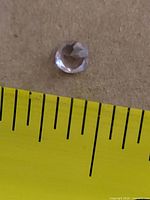 Gemstone beside ruler showing ~5 mm diameter