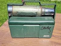 Front view of cooler with thermos secured on top