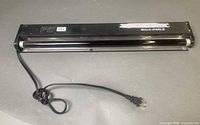 Full view of 2-foot American DJ UV light with cord