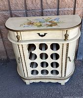 Front view of cream floral wine rack cabinet showing drawer, 12-bottle rack and overall design