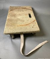 Top view of carpeted dolly showing cutout handle and pull strap