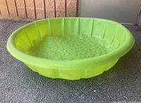 Overall view of green plastic kiddie pool